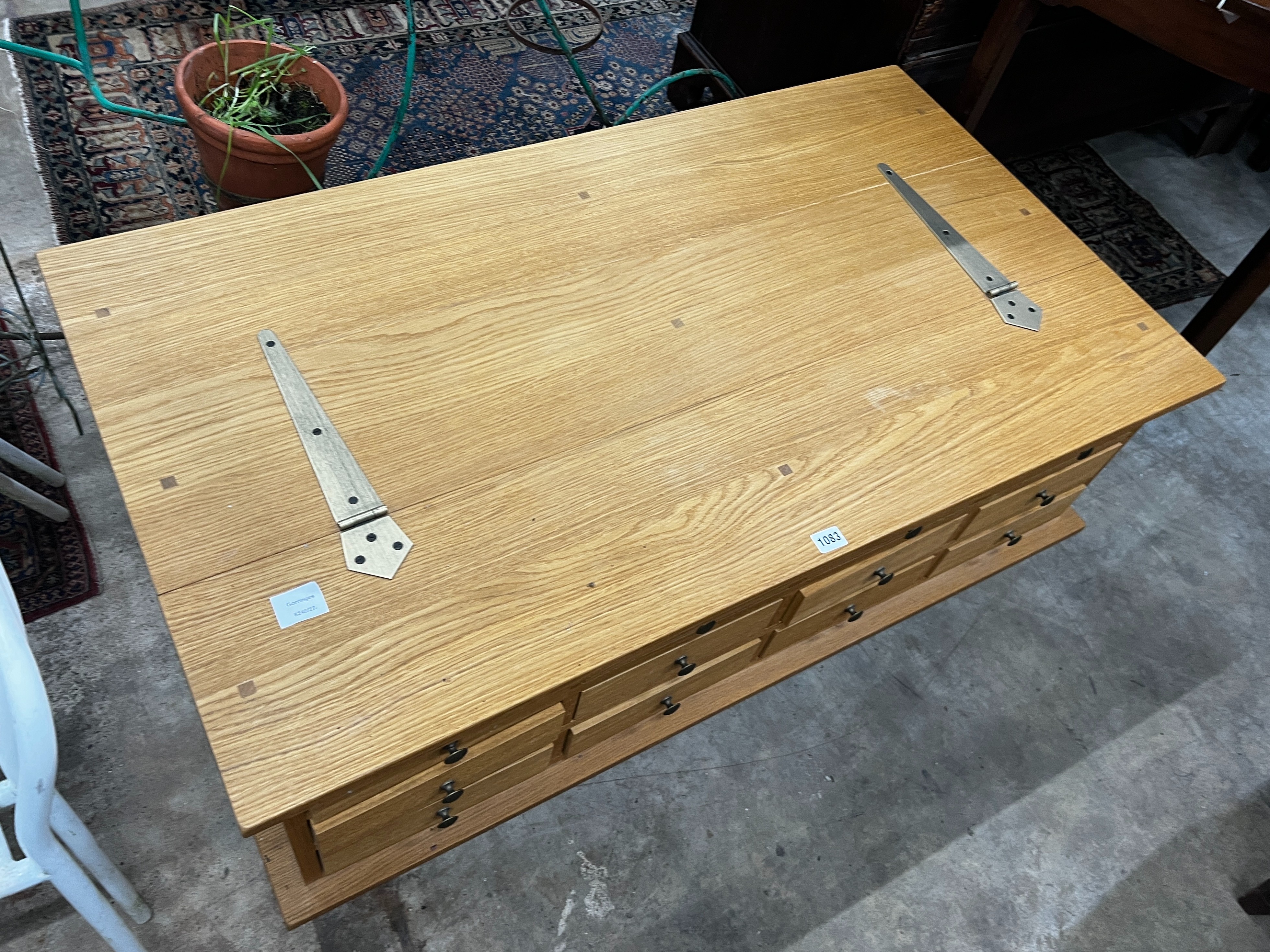 A contemporary Laura Ashley Garrat oak hinged top 12 drawer storage coffee table, length 118cm, depth 66cm, height 44cm